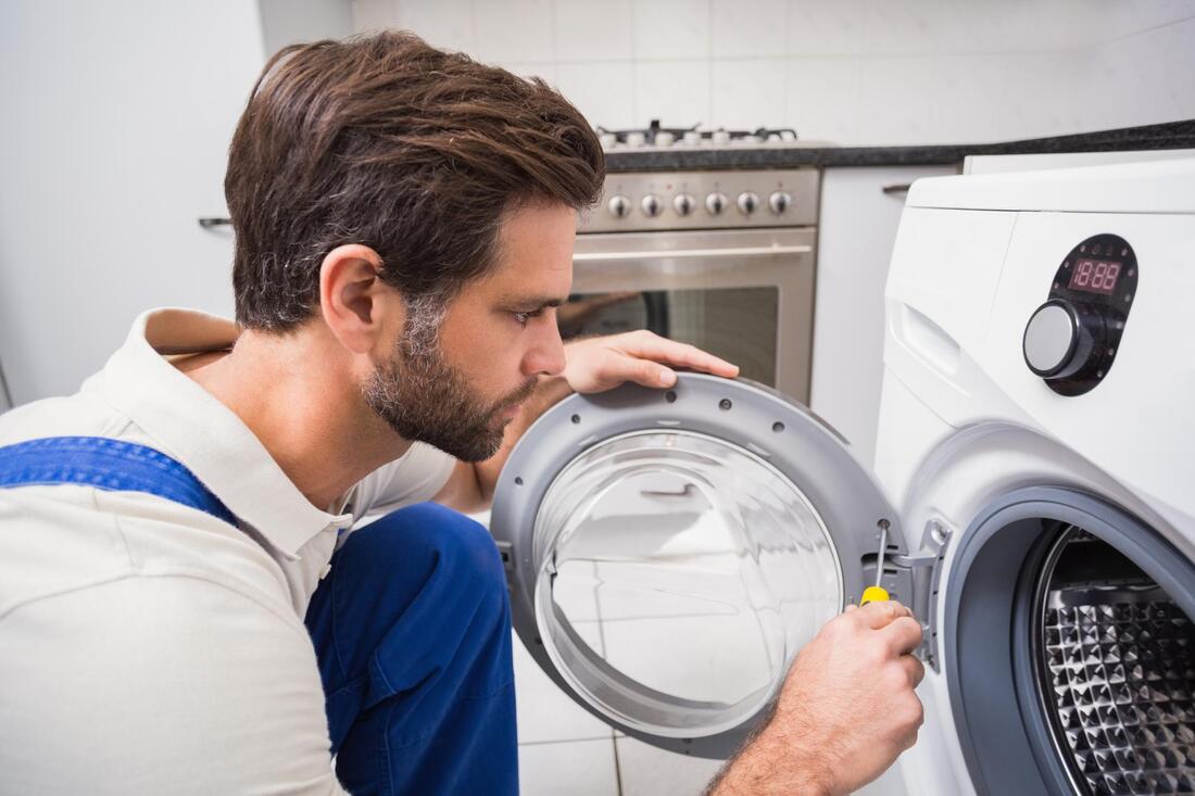 man screwing the dryer