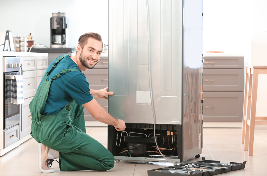 man happily fixing the refrigerator