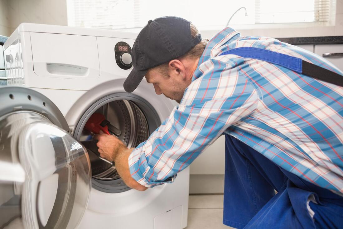 a man repairing the washer